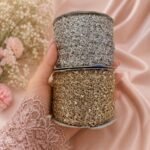 Add a luxurious finishing touch to your ethnic and designer outfits with the Zexira Golden & Silver Combo Kinari 36 Meter Lace. This premium combo pack includes 36 meters of elegant kinari lace (18 meters Golden + 18 meters Silver), making it an ideal choice for fashion designers, boutiques, tailors, resellers, and DIY craft enthusiasts. The beautiful metallic finish and intricate zari-inspired design create a rich, festive look that enhances every garment with elegance and style. Combo kinari lace is widely used for traditional Indian wear because of its versatility and timeless appeal. Crafted with quality materials, this decorative lace is lightweight, durable, and easy to stitch or glue onto fabrics. The shimmering gold and silver colors complement a wide range of outfits, allowing you to mix and match according to your design needs. Whether you're creating festive attire or upgrading everyday ethnic wear, this lace delivers a professional and premium finish. Perfect for decorating saree borders, dupattas, lehengas, kurtis, salwar suits, blouses, gowns, sherwanis, jackets, potlis, cushions, table runners, torans, gift wrapping, and various home décor or DIY craft projects. It is also an excellent choice for wedding wear, festive collections, Navratri, Diwali, Eid, bridal outfits, stage costumes, dance dresses, and boutique tailoring. Product Features Brand: Zexira Product: Golden & Silver Combo Kinari Lace Total Length: 36 Meters (18M Golden + 18M Silver) Color: Golden & Silver Material: Premium Decorative Kinari Lace Finish: Elegant Metallic Shine Easy to Stitch: Suitable for machine and hand sewing Reusable & Durable: Long-lasting quality for multiple projects Enhance every creation with a touch of elegance using the Zexira Golden & Silver Combo Kinari 36 Meter Lace—the perfect combination of premium quality, attractive design, and exceptional value for fashion and craft applications. Inspired by the decorative kinari and zari trims commonly used in ethnic apparel, this combo offers both versatility and a refined finish for creative projects.